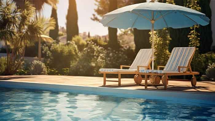 Swimming pool and loungers at Evara Shades